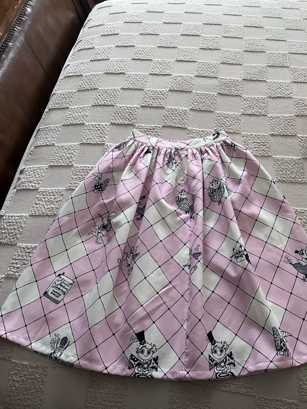 Tatyana pink and white argyle-patterned swing skirt featuring character art